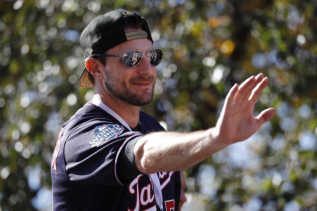 Washington Nationals starting pitcher Max Scherzer waves to fans before a parade to celebrate t ...