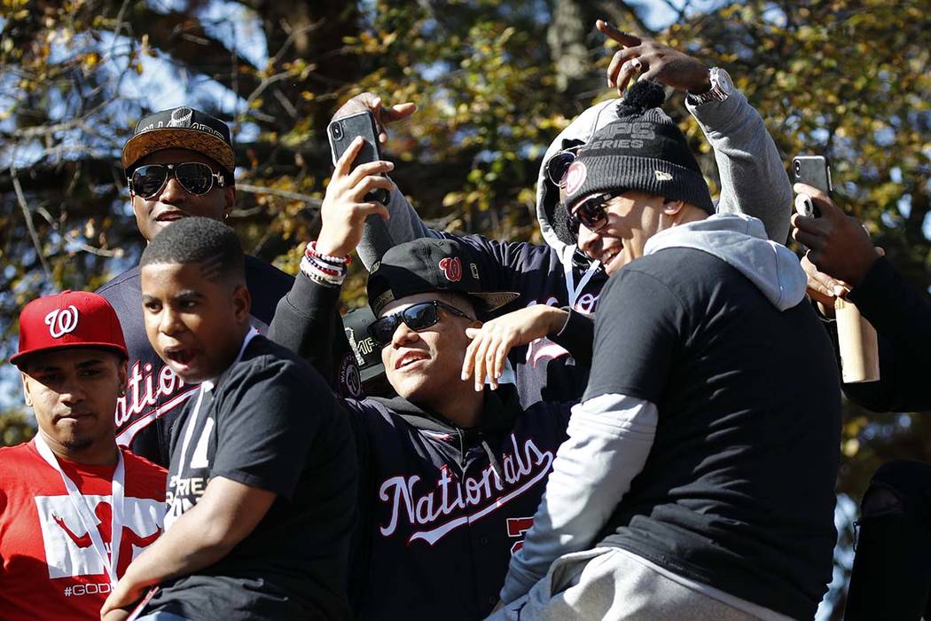 Washington Nationals left fielder Juan Soto, center, celebrates with teammates before a parade ...