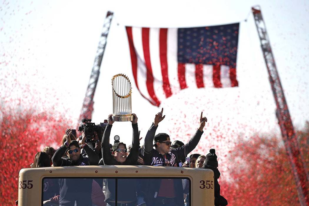 Washington Nationals general manager Mike Rizzo holds up the World Series trophy during a parad ...