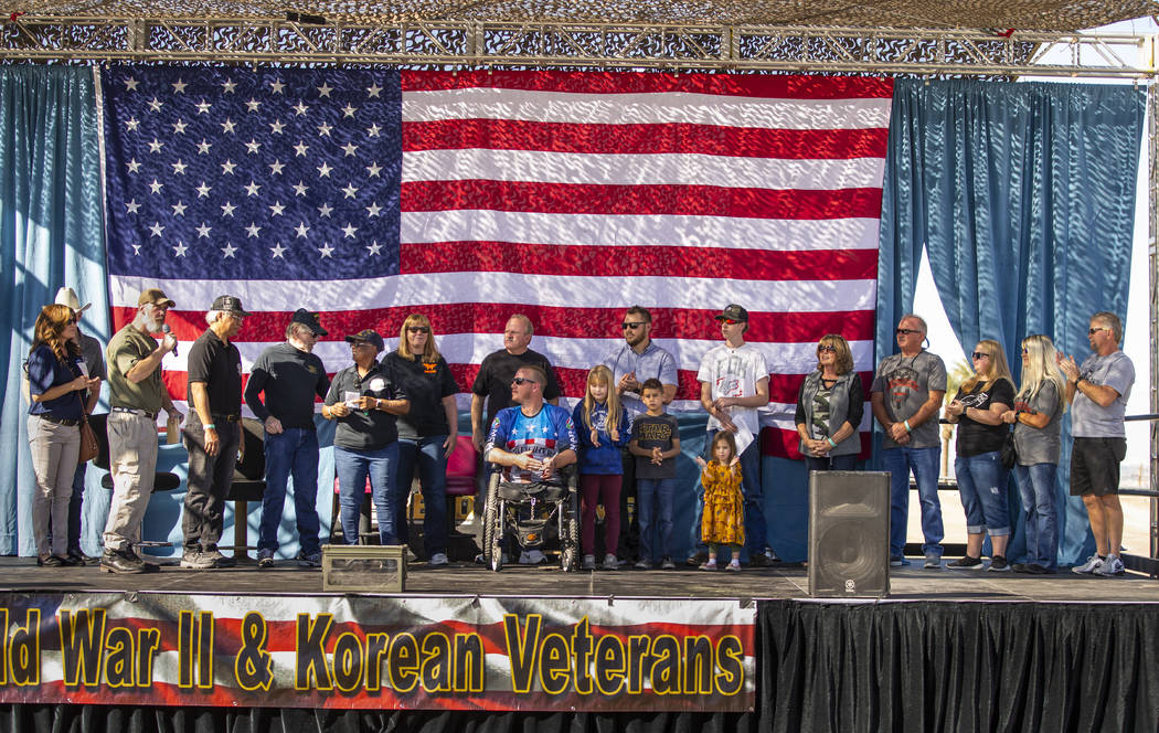 Veteran Tim Hall, center, surrounded by his family on stage receives a check during the 10th An ...