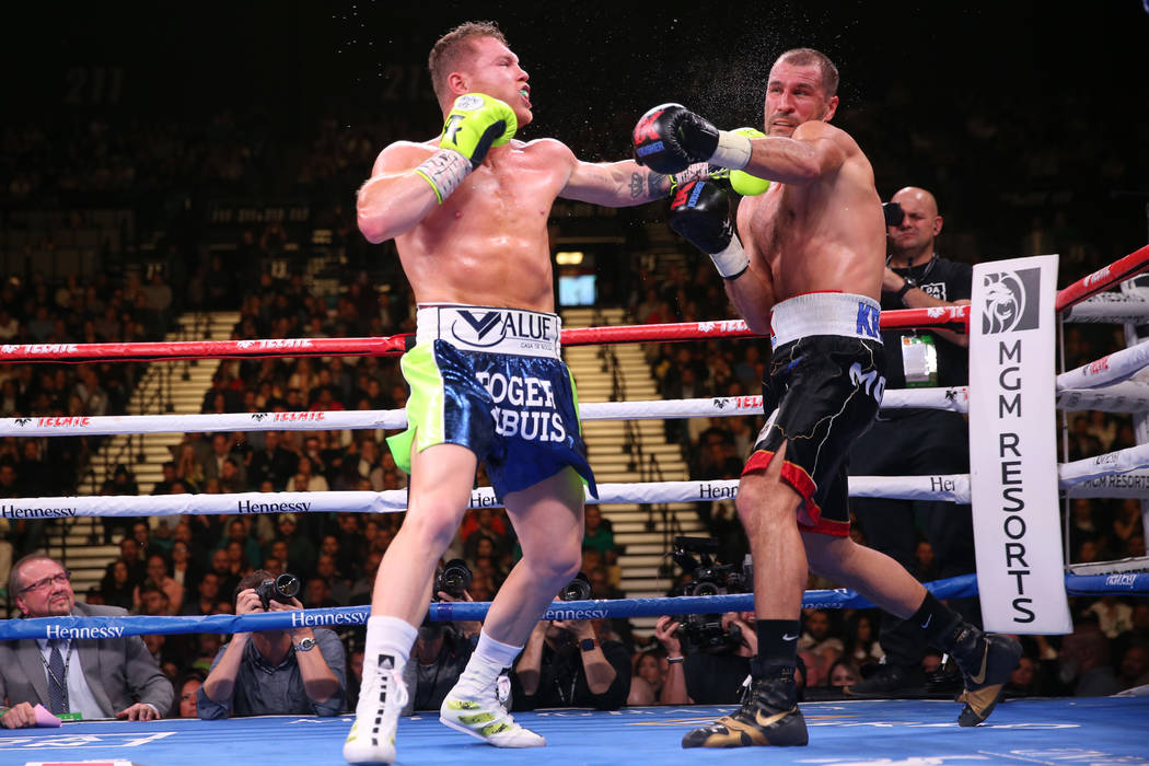 Saul “Canelo” Alvarez, left, connects a punch against Sergey Kovalev during the f ...
