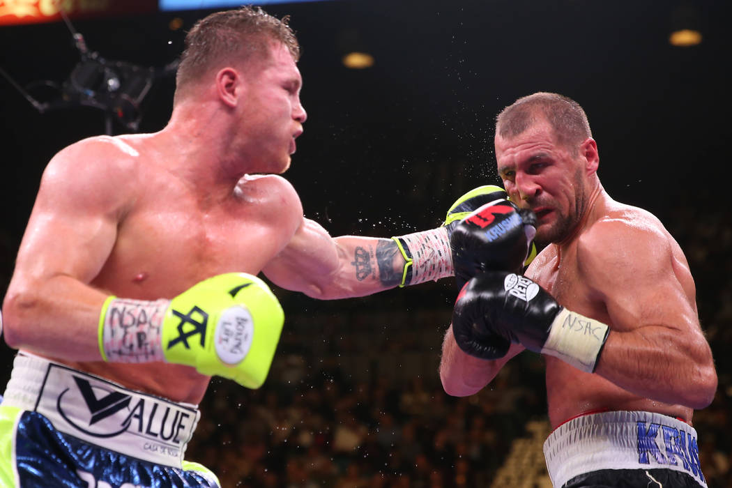 Saul “Canelo” Alvarez, left, connects a punch against Sergey Kovalev during the 1 ...