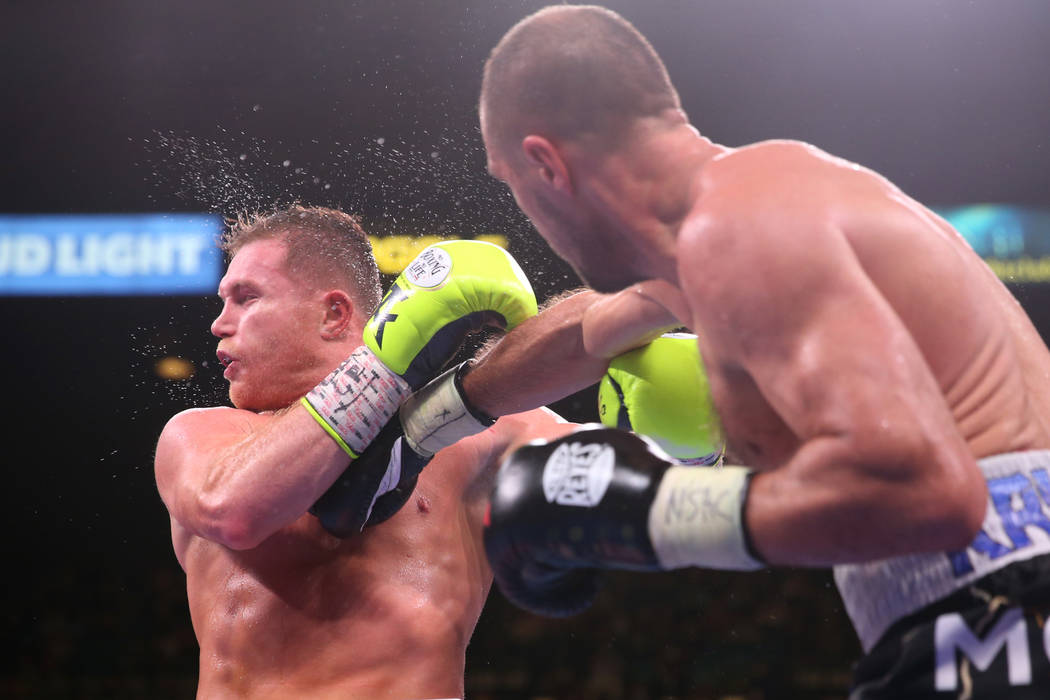 Saul “Canelo” Alvarez, left, takes a punch against Sergey Kovalev during the nint ...