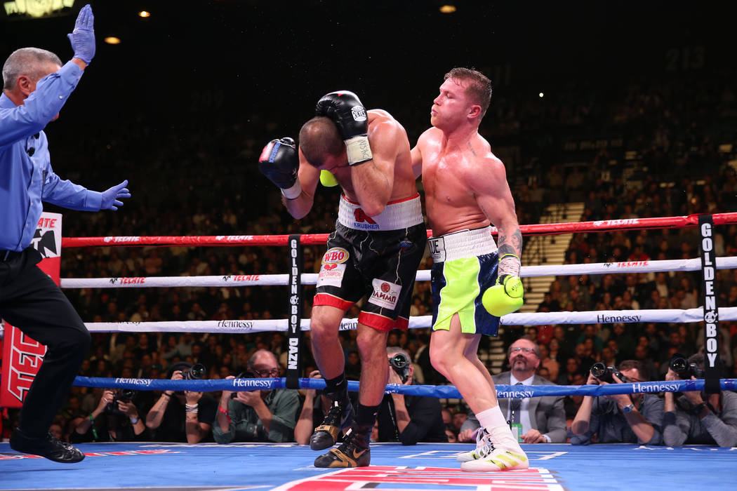 Saul “Canelo” Alvarez, right, gets ready for a punch against Sergey Kovalev during the nint ...