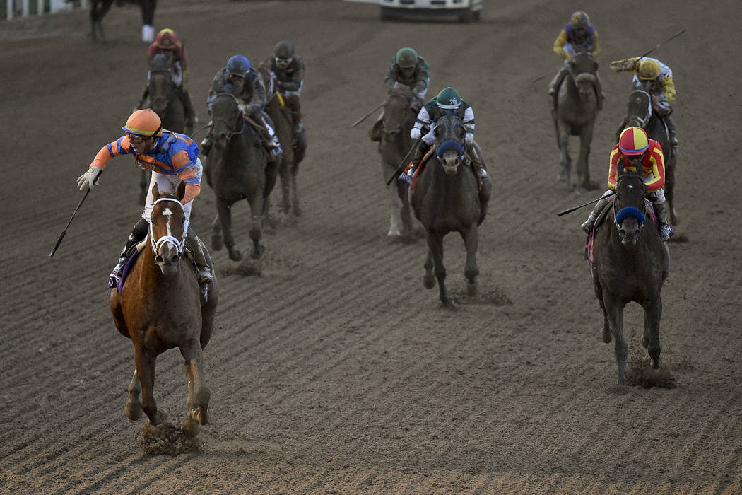 Irad Ortiz Jr., left, aboard Vino Rosso celebrates after winning the Breeders' Cup Classic hors ...