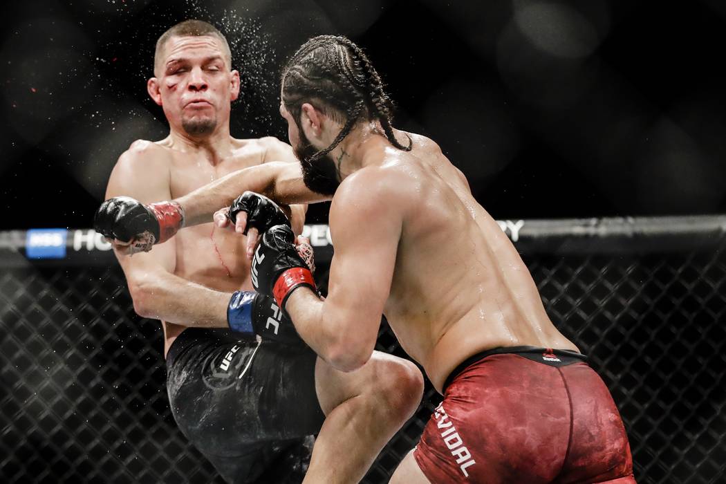 Jorge Masvidal, right, punches Nate Diaz during the third round of a welterweight mixed martial ...