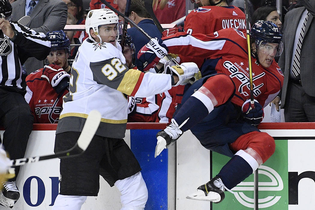 Vegas Golden Knights left wing Tomas Nosek (92) checks Washington Capitals right wing T.J. Oshi ...