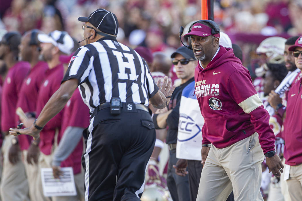 Florida State head coach Willie Taggart, right, disagrees with the referee in the first half of ...