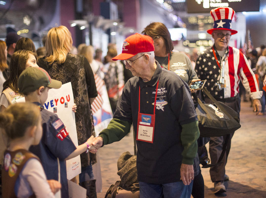 Rollie Tatro, a veteran of the U.S. Air Force, greets supporters after visiting the veteran mem ...