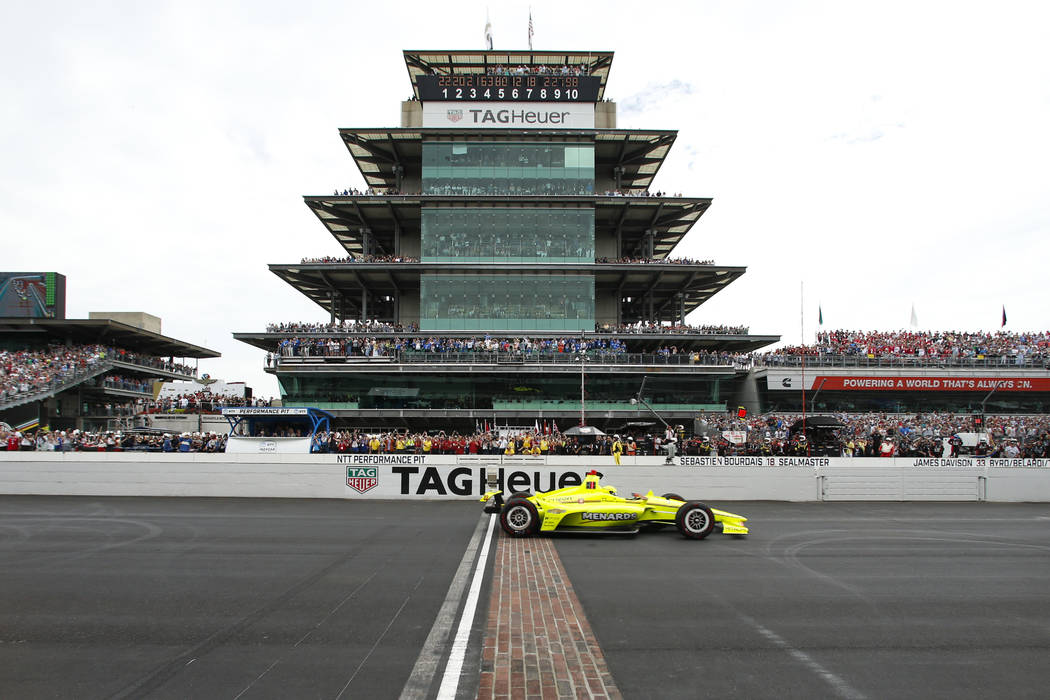 FILE - In this May 26, 2019, file photo, Simon Pagenaud, of France, crosses the start/finish li ...