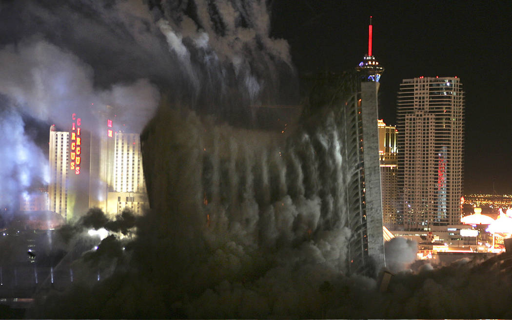 Behind an expanding cloud of dust the Stardust hotel-casino falls in on itself as it is implode ...