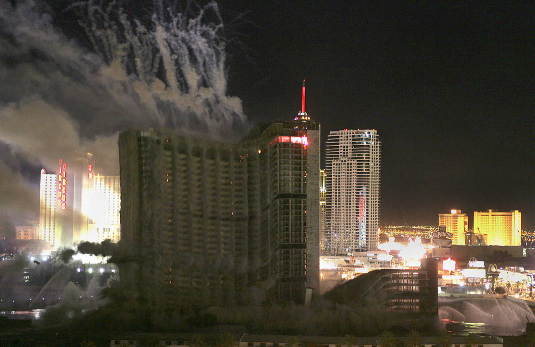 Behind an expanding cloud of dust the Stardust hotel-casino falls in on itself as it is implode ...