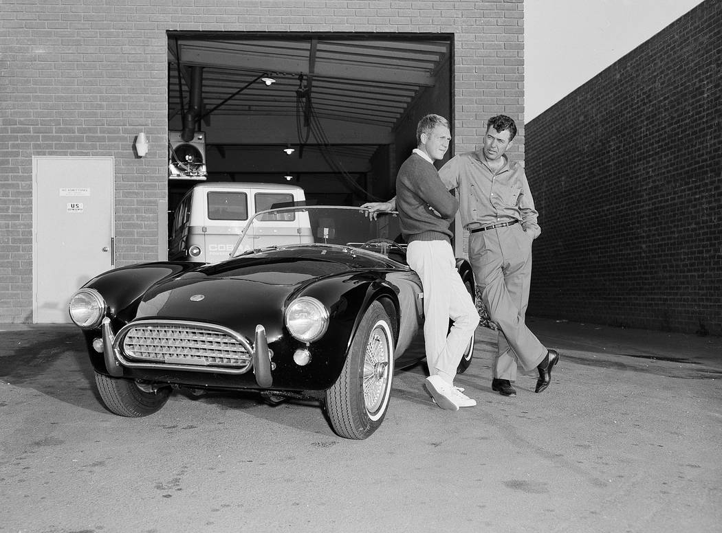 Actor Steve McQueen, left, and racer Carroll Shelby stand by McQueen's Ford-Cobra roadster, Jun ...