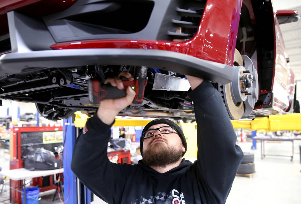 Assembly technician Javier Chaves installs a brake duct cooling system on a 2020 Ford Mustang S ...