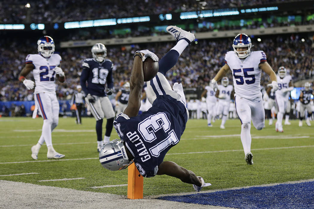 Dallas Cowboys wide receiver Michael Gallup (13) stays in bounds as he flips over the goal line ...