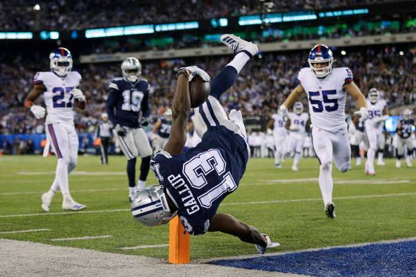 Dallas Cowboys wide receiver Michael Gallup (13) stays in bounds as he flips over the goal line ...