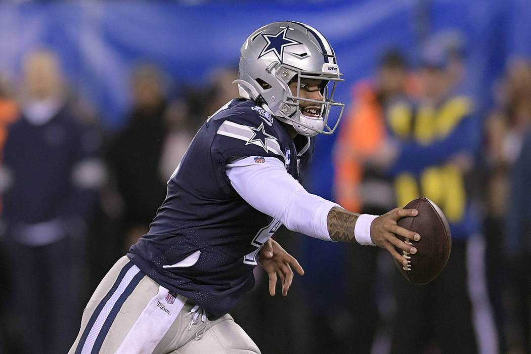 Dallas Cowboys quarterback Dak Prescott (4) passes off the ball during the second quarter of an ...