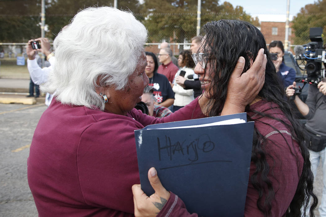 Sally Taylor, left, embraces her granddaughter Tess Harjo, right, after Harjo was released from ...