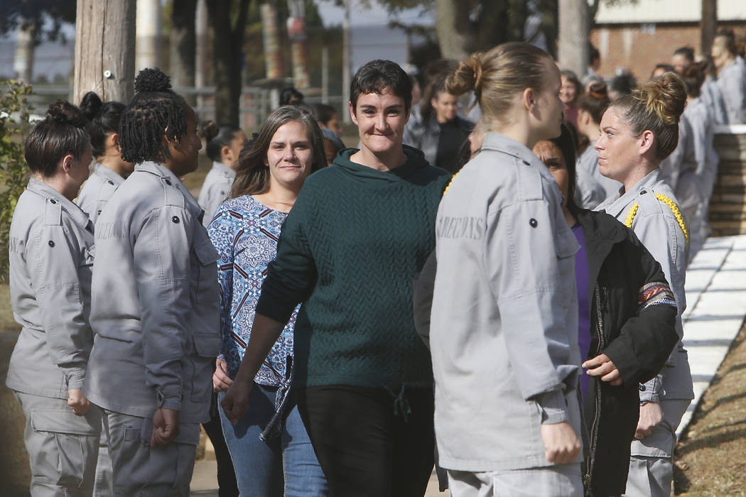 Inmates being released from the Eddie Warrior Correctional Center walk through a line of inmate ...