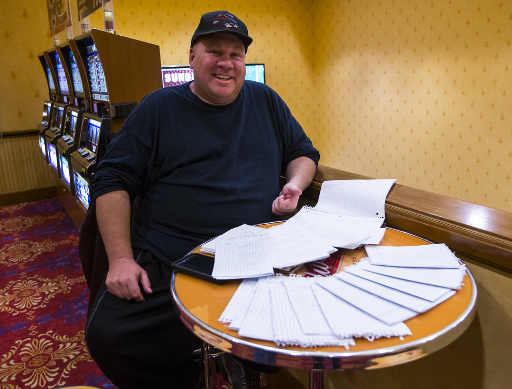 Dyer Lawrence poses with his college football playoff rankings at South Point in Las Vegas on F ...