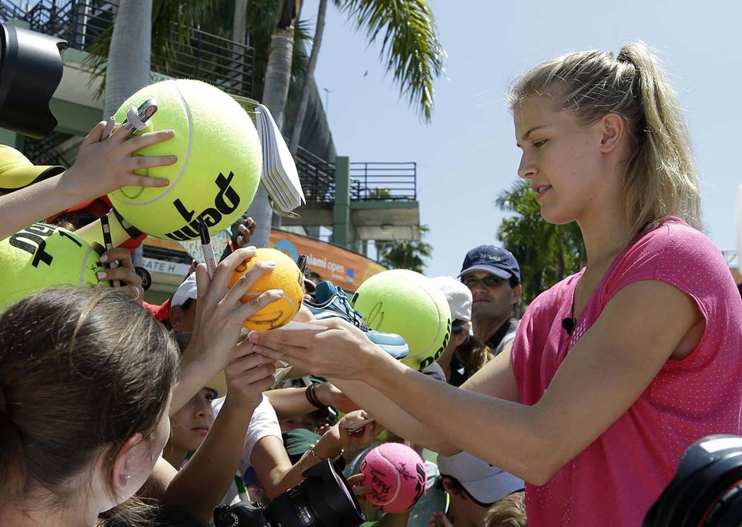 In this March 24, 2015, file photo, Genie Bouchard, of Canada, signs autographs at the Miami Op ...