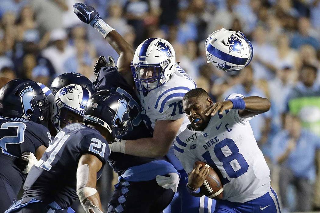 Duke quarterback Quentin Harris (18) loses his helmet during the second half of an NCAA college ...