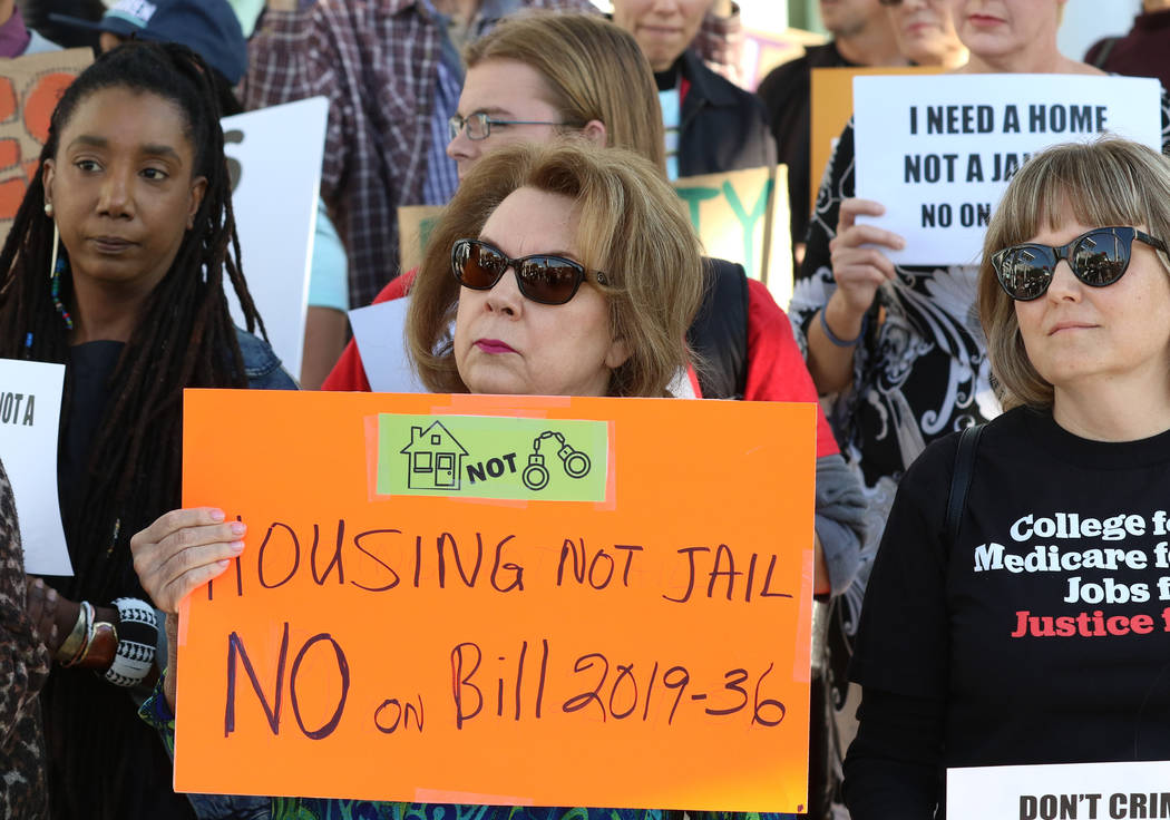 Eva Love, left, and Deidre Radford of Las Vegas hold signs outside Las Vegas City Hall as they ...