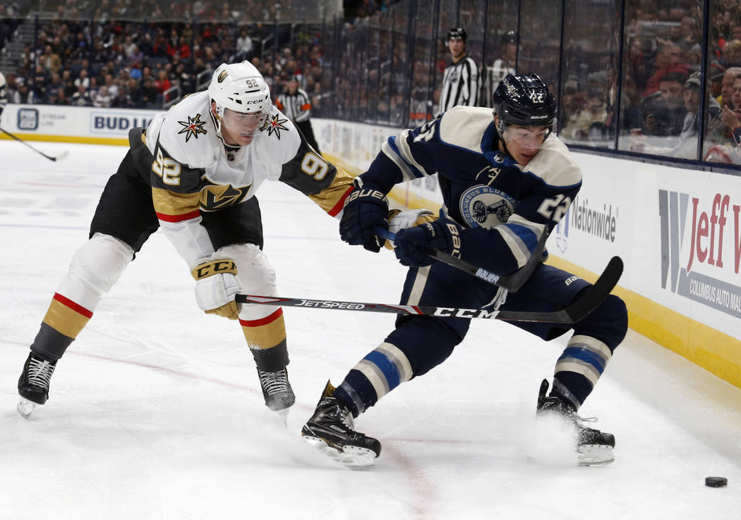 Columbus Blue Jackets forward Sonny Milano, right, chases the puck in front of Vegas Golden Kni ...