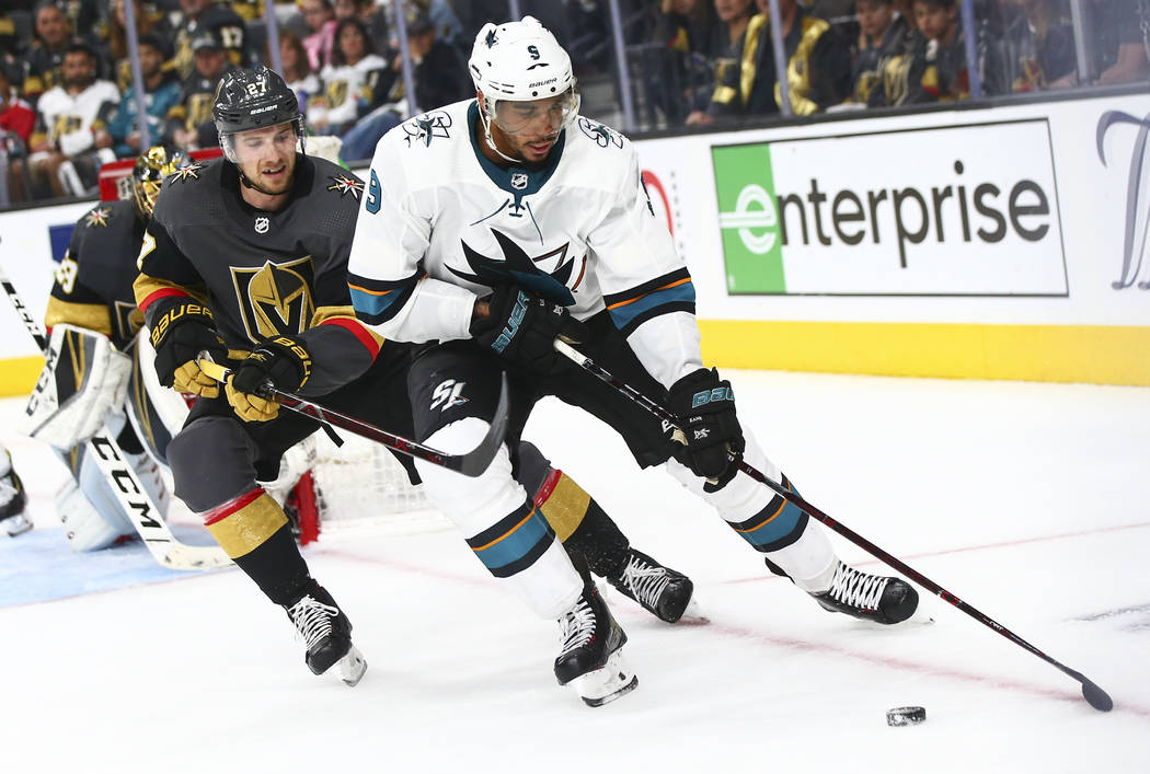 San Jose Sharks left wing Evander Kane (9) skates with the puck under pressure from Golden Knig ...