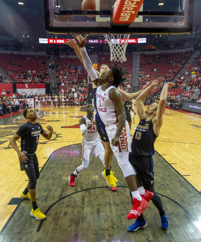 UNLV Rebels forward Donnie Tillman (2) gets inside of Purdue Fort Wayne forward Matt Holba (13) ...