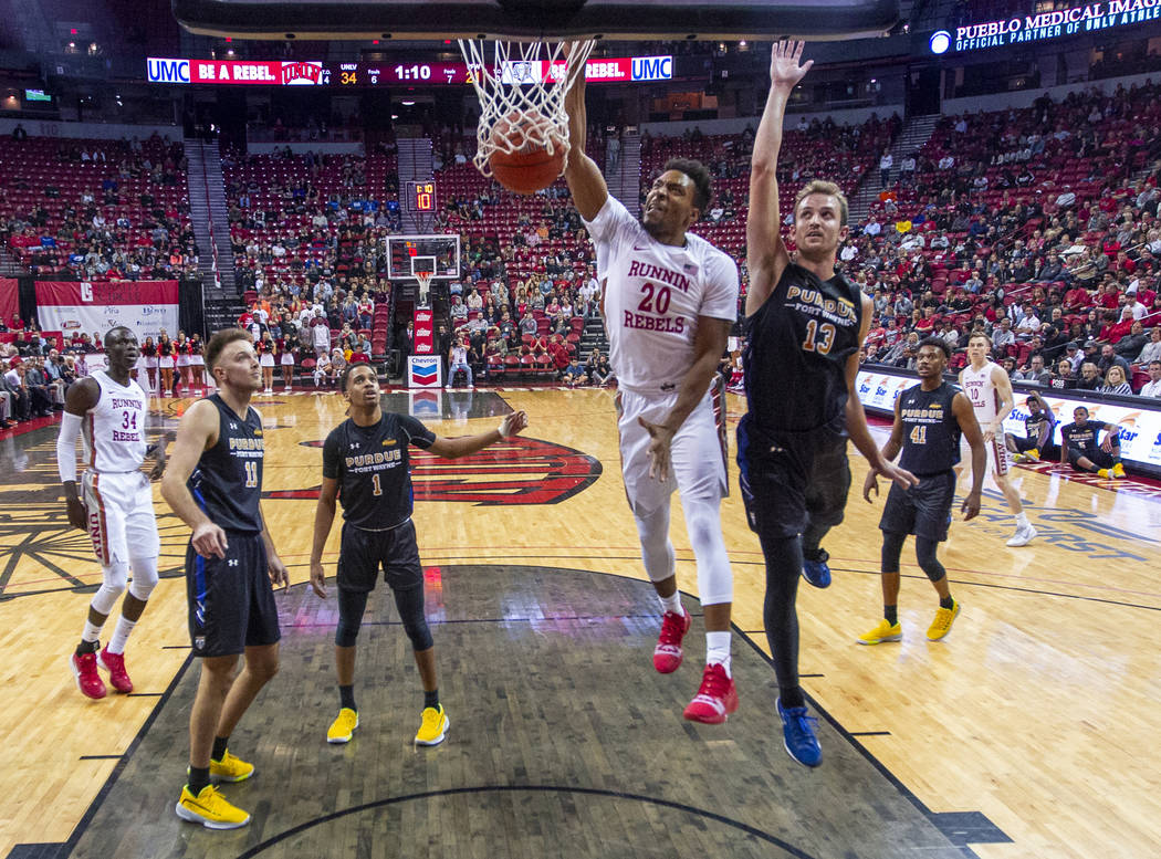 UNLV Rebels forward Nick Blair (20) dunks the ball over Purdue Fort Wayne forward Matt Holba (1 ...