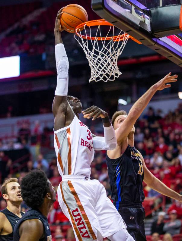 UNLV Rebels guard Amauri Hardy (3) attempts a dunk over Purdue Fort Wayne forward Dylan Carl (1 ...