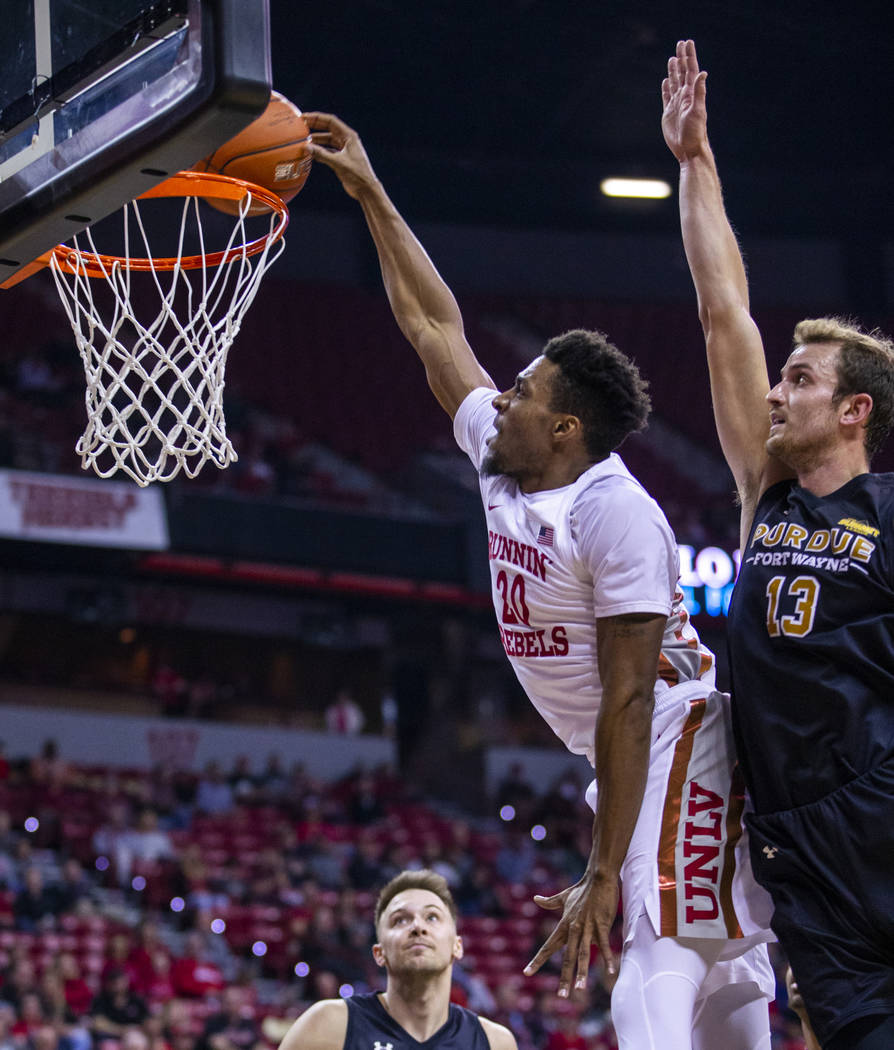 UNLV Rebels forward Nick Blair (20) lays in the ball past Purdue Fort Wayne forward Matt Holba ...