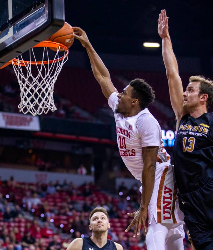 UNLV Rebels forward Nick Blair (20) lays in the ball past Purdue Fort Wayne forward Matt Holba ...