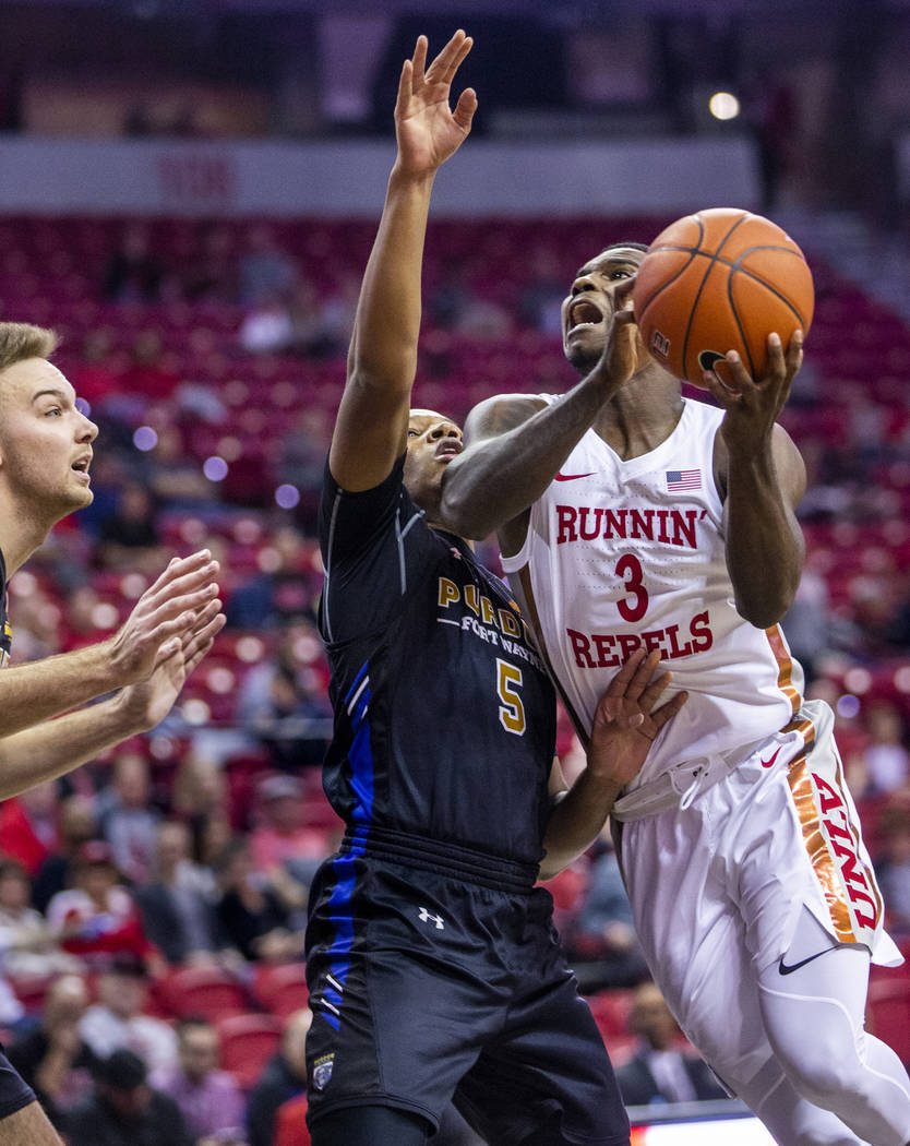 UNLV Rebels guard Amauri Hardy (3, right) elevates for a shot against Purdue Fort Wayne guard T ...