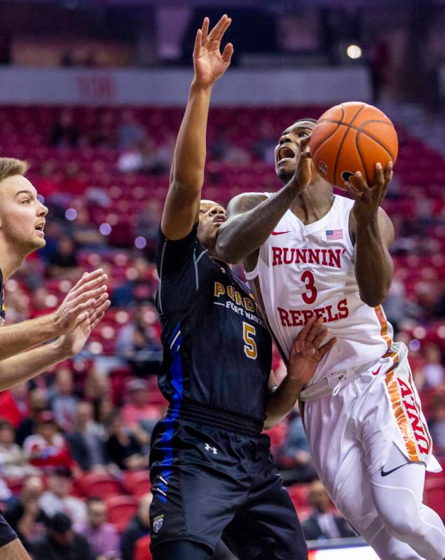 UNLV Rebels guard Amauri Hardy (3, right) elevates for a shot against Purdue Fort Wayne guard T ...