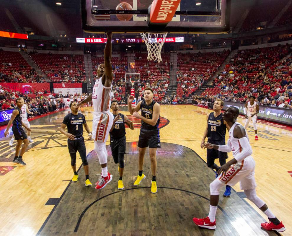 UNLV Rebels guard Amauri Hardy (3) slides between Purdue Fort Wayne defenders for a basket duri ...