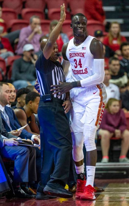 UNLV Rebels forward Cheikh Mbacke Diong (34) catches a referee after running out of bounds to c ...