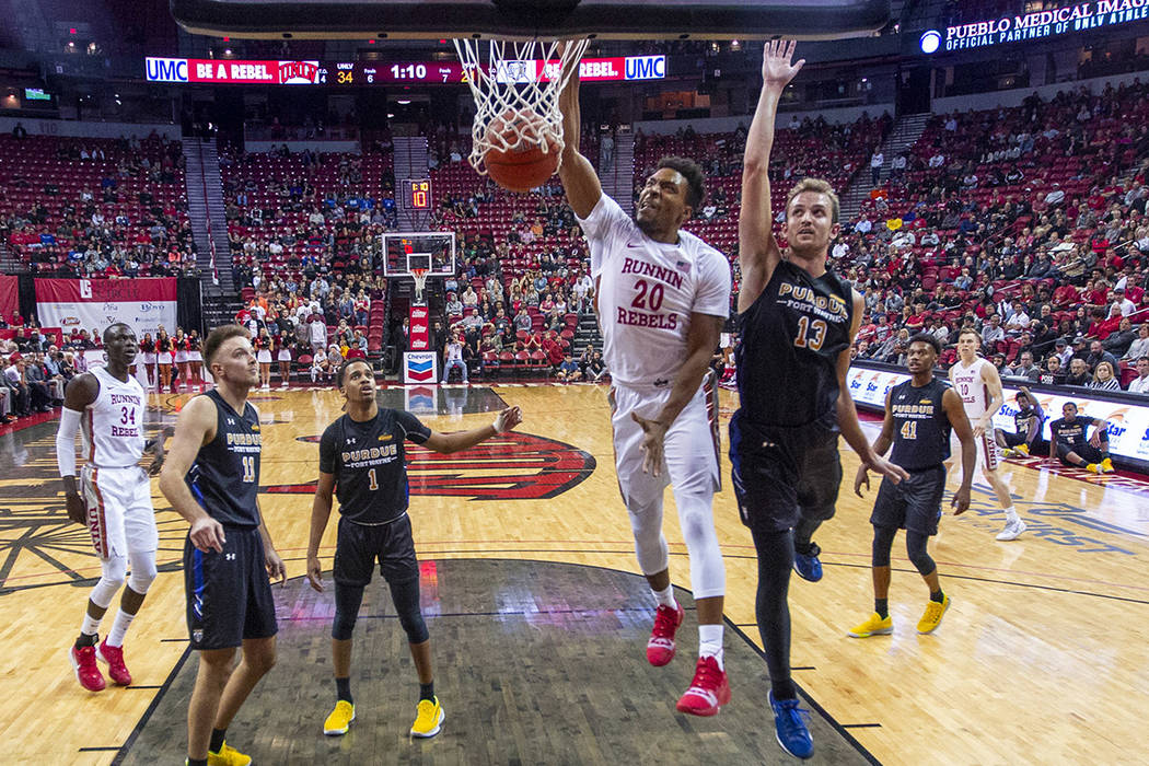 UNLV Rebels forward Nick Blair (20) dunks the ball over Purdue Fort Wayne forward Matt Holba (1 ...