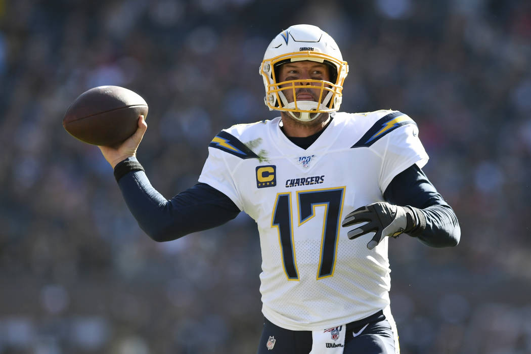 Los Angeles Chargers quarterback Philip Rivers, center, throws a pass during the second half of ...