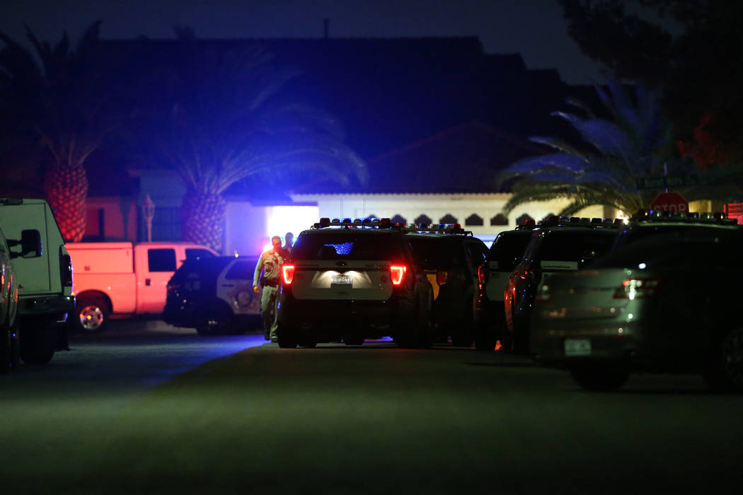 Las Vegas police officers at the intersection of W Sadler Drive and N Bannister Lane investigat ...