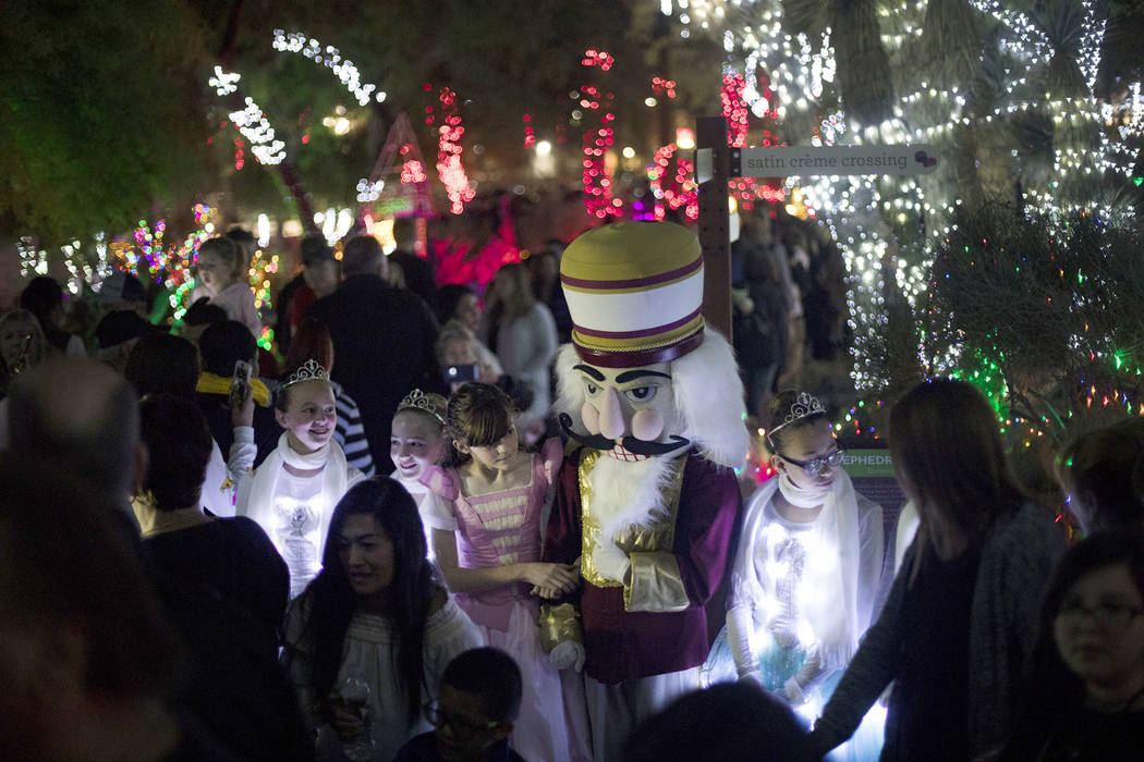 Members of the Nevada Ballet Theatre greet guests as they walk through the Ethel M Chocolates c ...