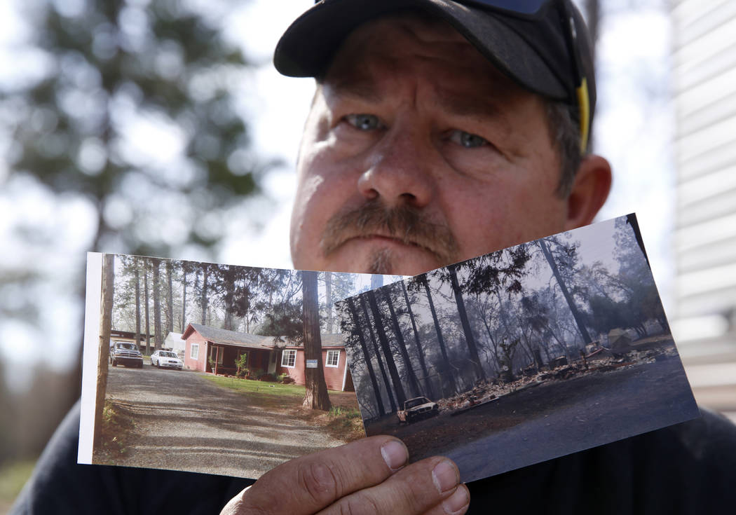 In this Thursday Oct. 24, 2019, photo, Bill Husa displays before-and-after photos of his home l ...