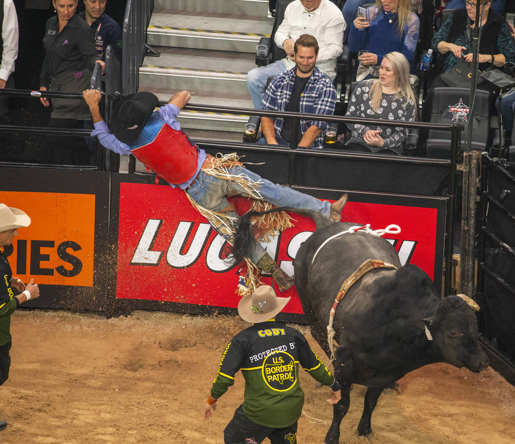 Alan de Souza grabs onto the rails after a successful ride on Mad Child during the PBR World Fi ...