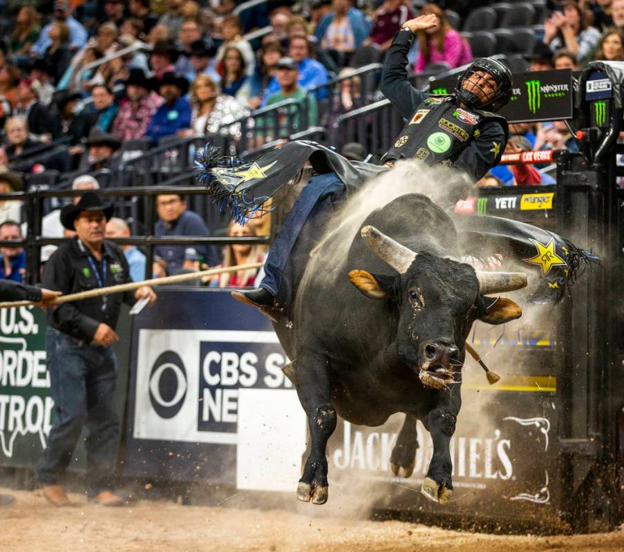 Luciano De Castro hangs tight atop Gangster Party during the PBR World Finals at T-Mobile Arena ...