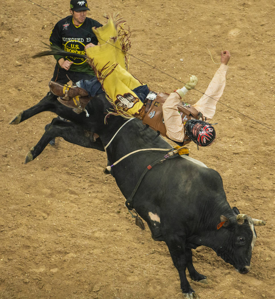 Daniel Tinsman flips over I'm Legit Too after getting the horns during the PBR Finals at T-Mobi ...