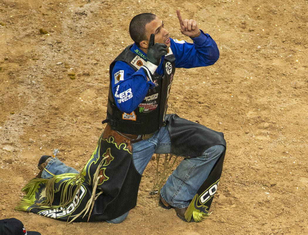Eduardo Aparecido celebrates a successful ride on Chiseled during the PBR World Finals at T-Mob ...