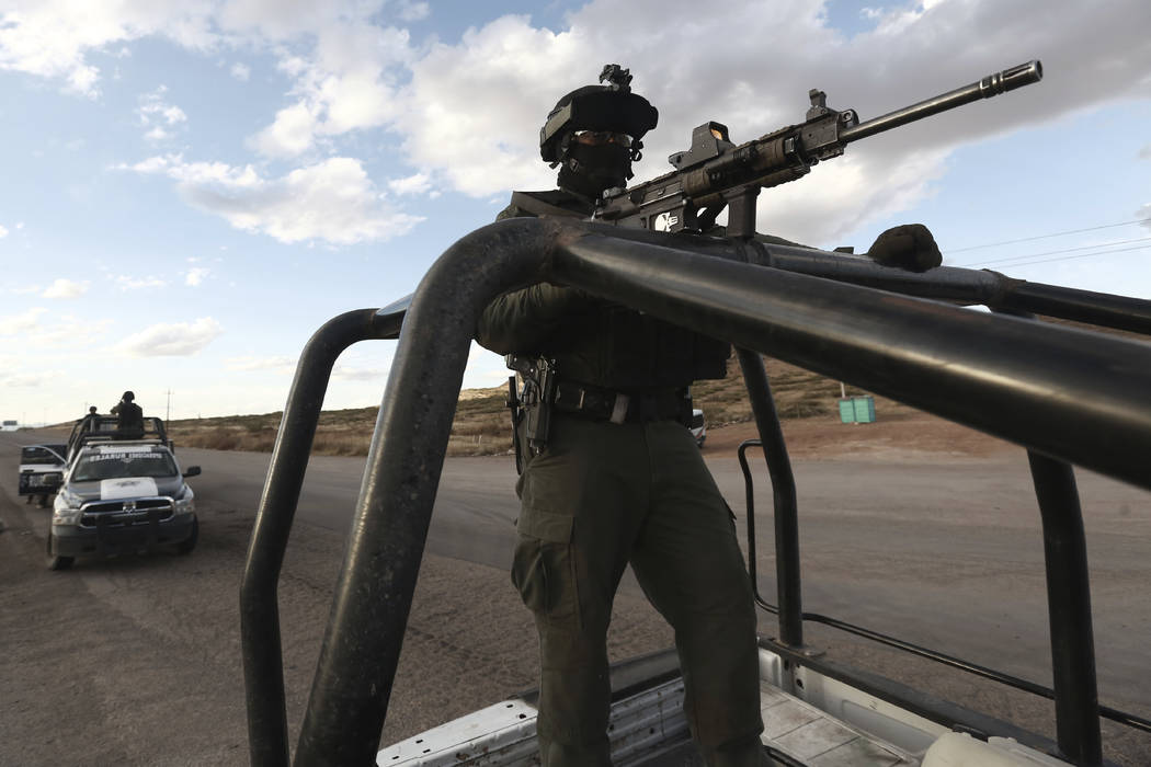 Chihuahua state police officers man a checkpoint in Janos, Chihuahua state, northern Mexico, Tu ...