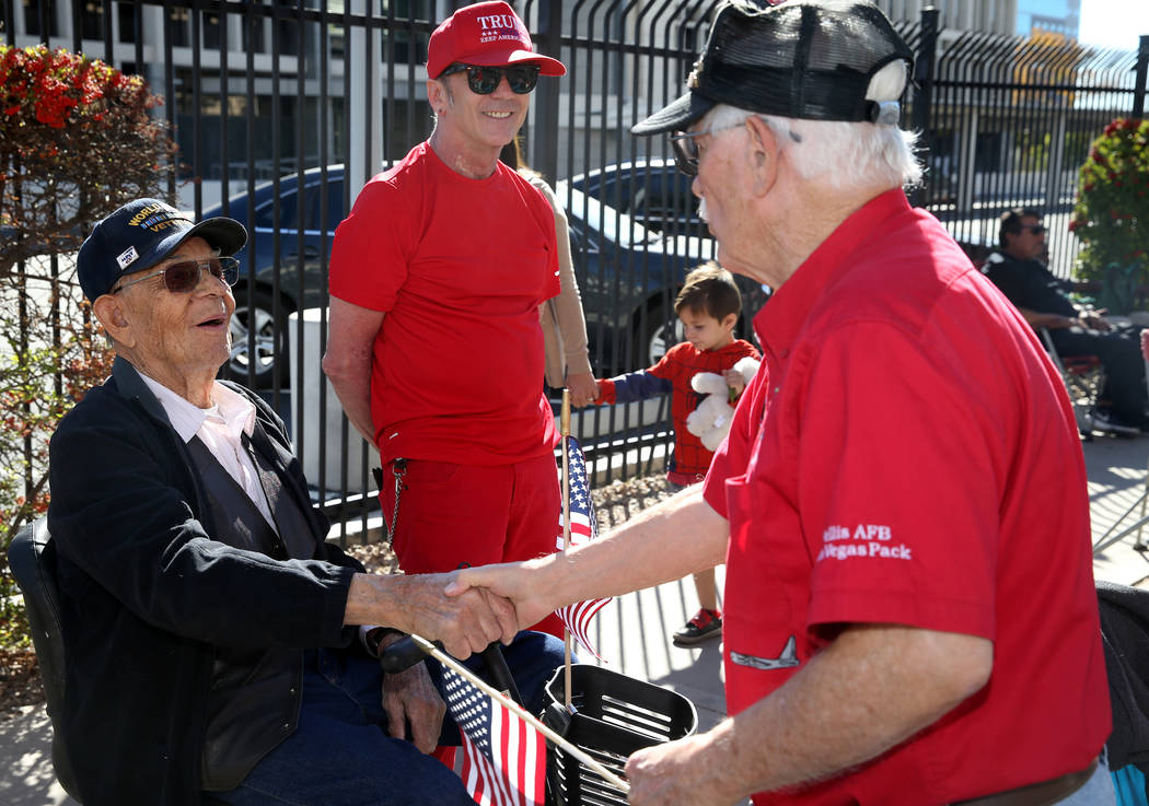 Don Harten, 80, thanks Robert Jensen, 96, and his son David Jensen, 63, in the Veterans Day Par ...