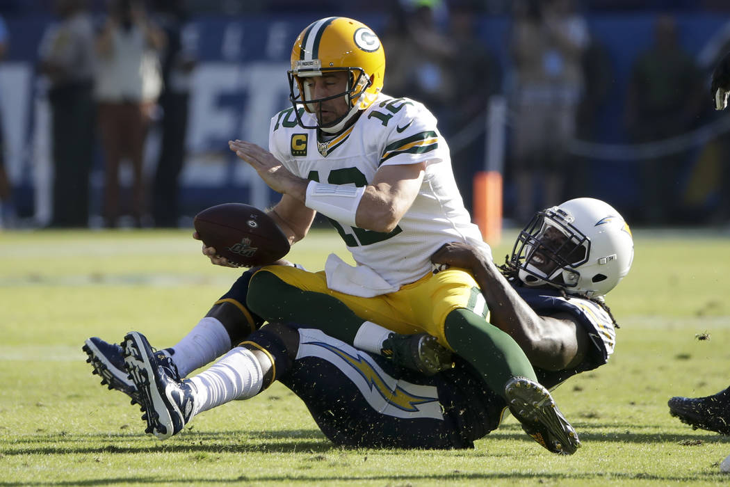 Green Bay Packers quarterback Aaron Rodgers is sacked by Los Angeles Chargers defensive end Mel ...